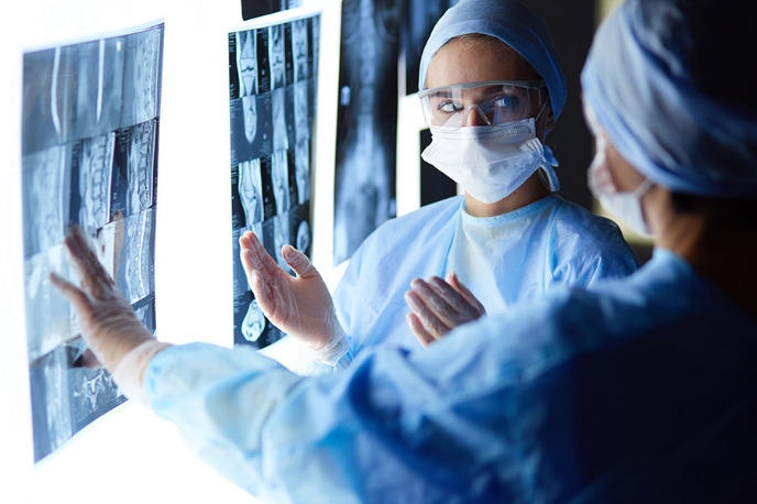 Two doctors examining x-rays.