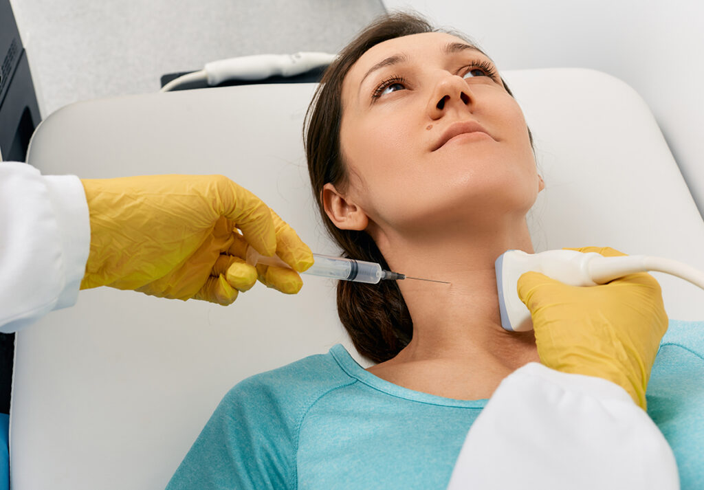 A woman about to undergo fine needle aspiration biopsy of the thyroid gland.