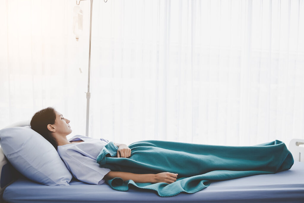 Patient person sleep on patient bed in hospital room.